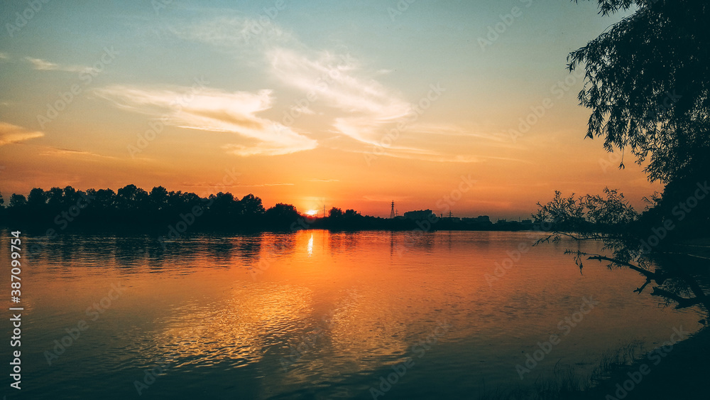 Sunset over the river in the city