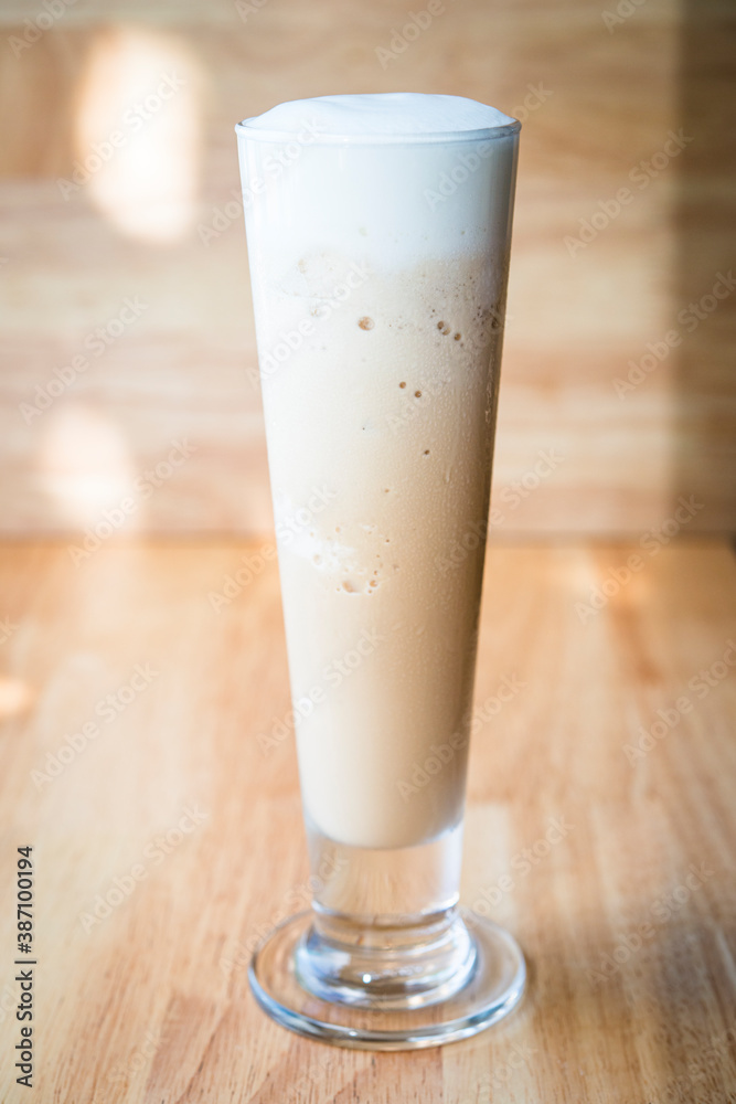 Iced coffee frappe on a woodon table with a wood background Iced coffee frappe on a woodon table with a wood background