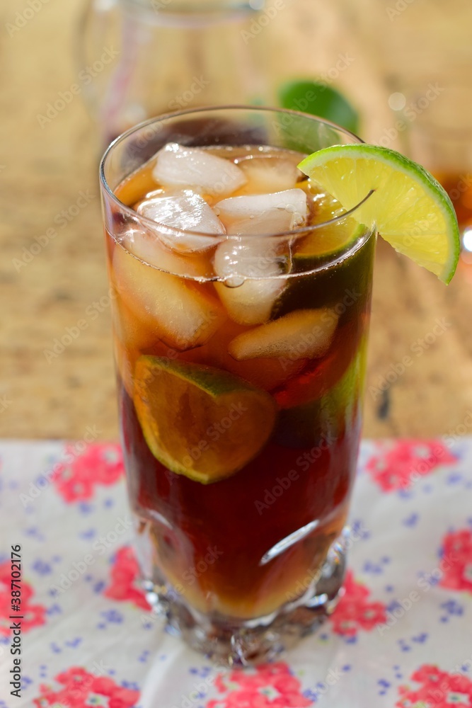 Rum and Coke Cocktail Drink with Lime Wedges and Ice Cubes. Cuba Libre Rum and Coke Cocktail Drink with Lime Wedges and Ice Cubes. Cuba Libre