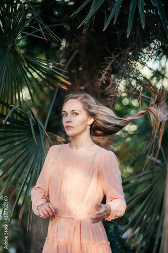 Portrait of a young,  gorgeous woman with beautiful long hair in summer park.