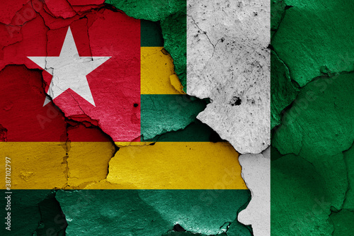 flags of Togo and Nigeria painted on cracked wall