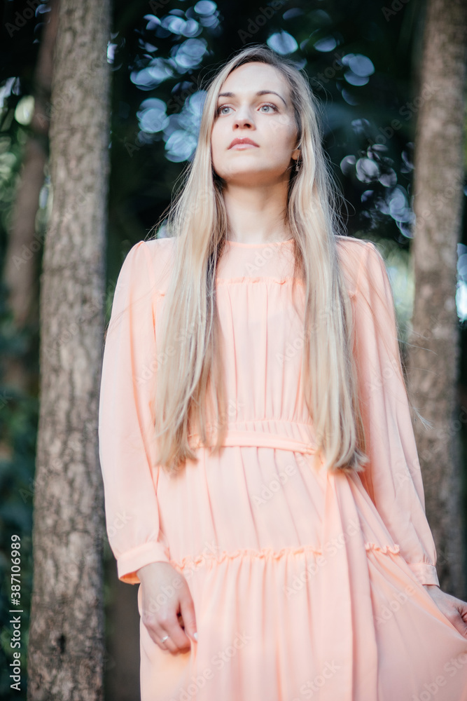 Portrait of a young, gorgeous woman with beautiful long hair in summer park. Portrait of a young, gorgeous woman with beautiful long hair in summer park.
