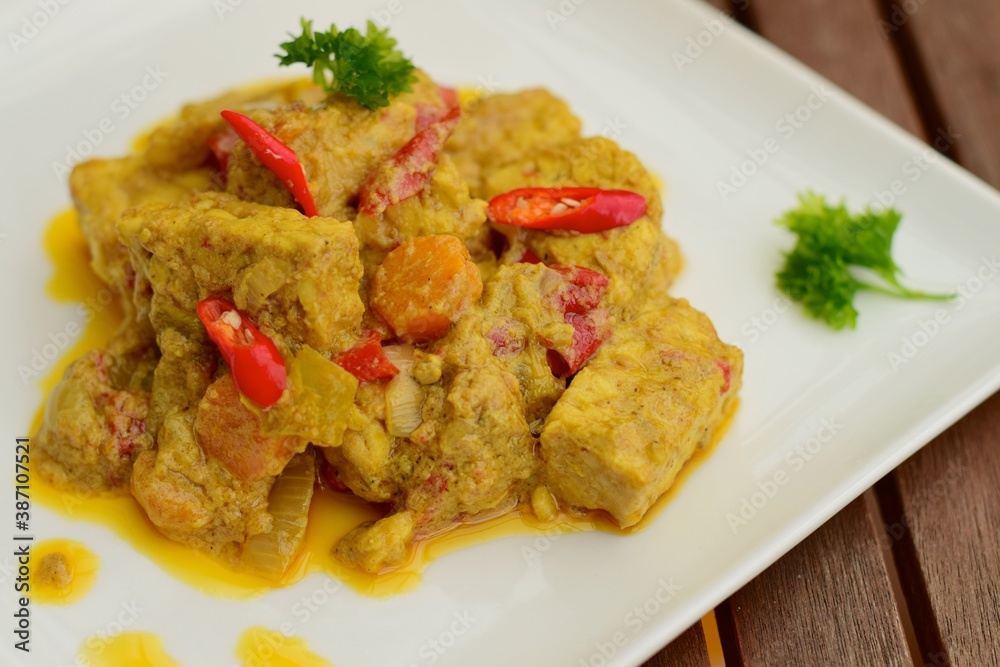 Spicy tempeh curry with carrot cooked in coconut milk and spices Spicy tempeh curry with carrot cooked in coconut milk and spices