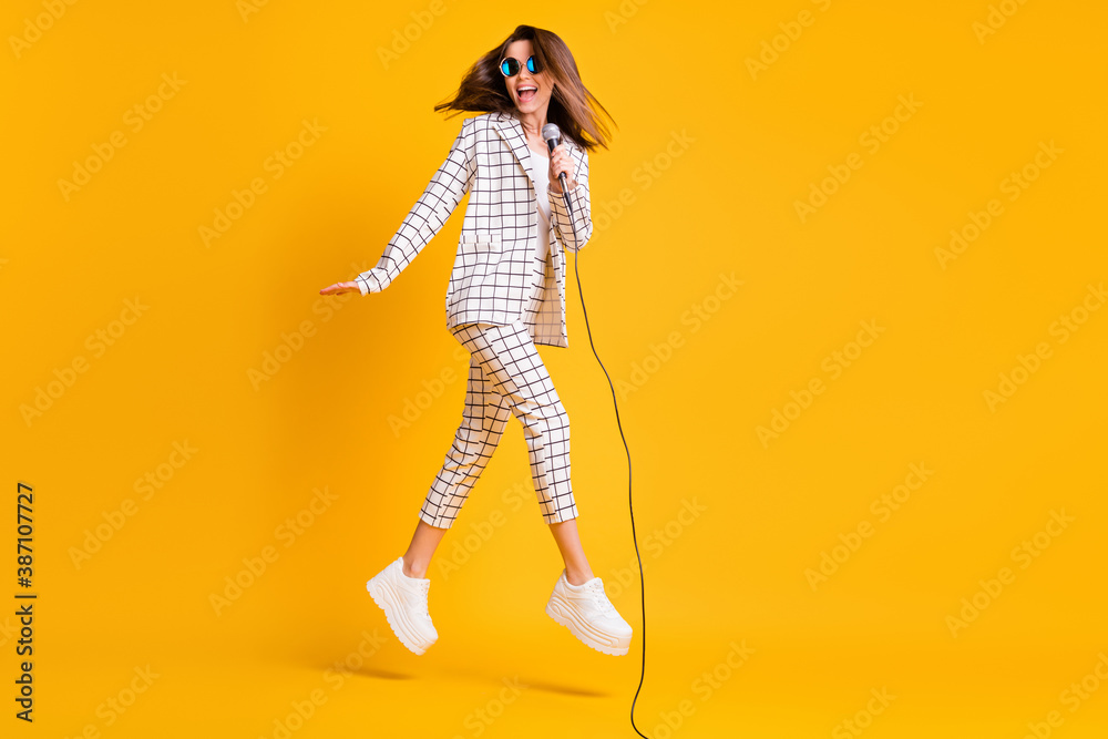Full length body size side profile photo of girl jumping with mic singing on concert isolated on vibrant color background - obrazy, fototapety, plakaty 