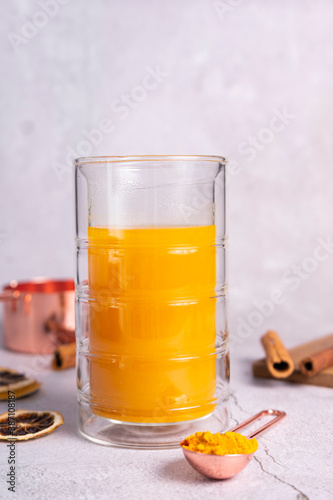 selective focus. honey cake with delicate cream. on a light background with craft paper. in the background is a jar of light honey photo