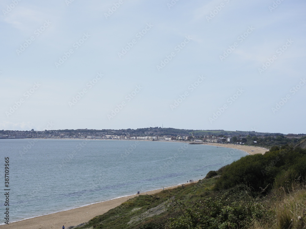 a view of Weymouth bay in Dorset, England, showing the sea and sand a view of Weymouth bay in Dorset, England, showing the sea and sand