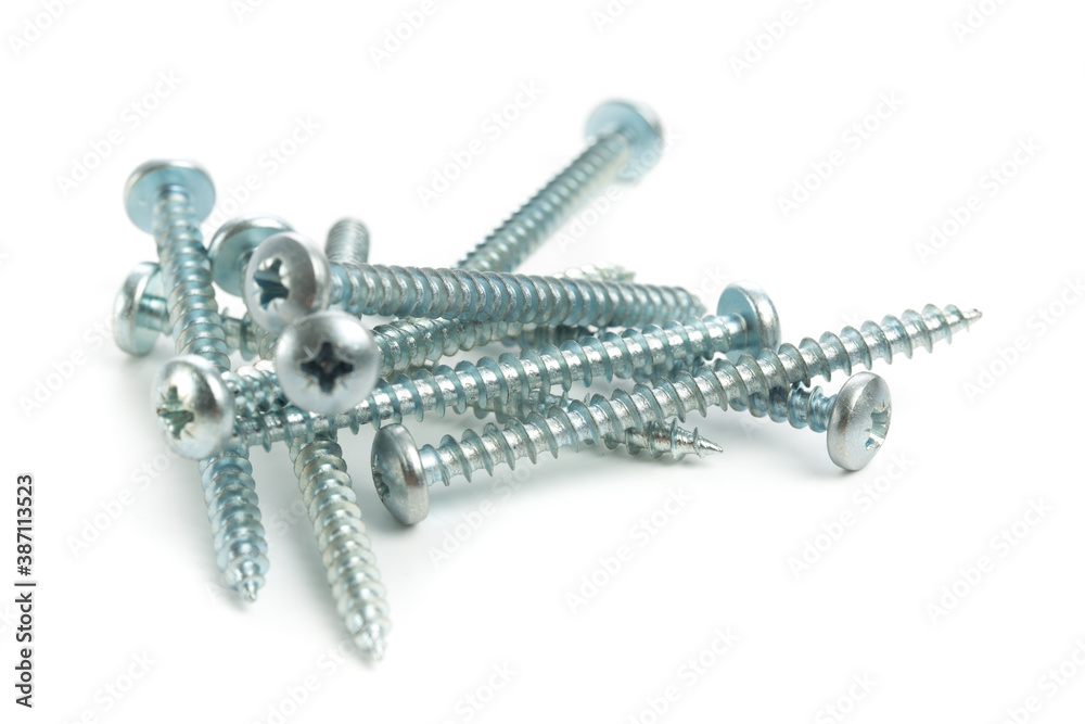 Stack of shiny metal screws isolated on white background. Stack of shiny metal screws isolated on white background.