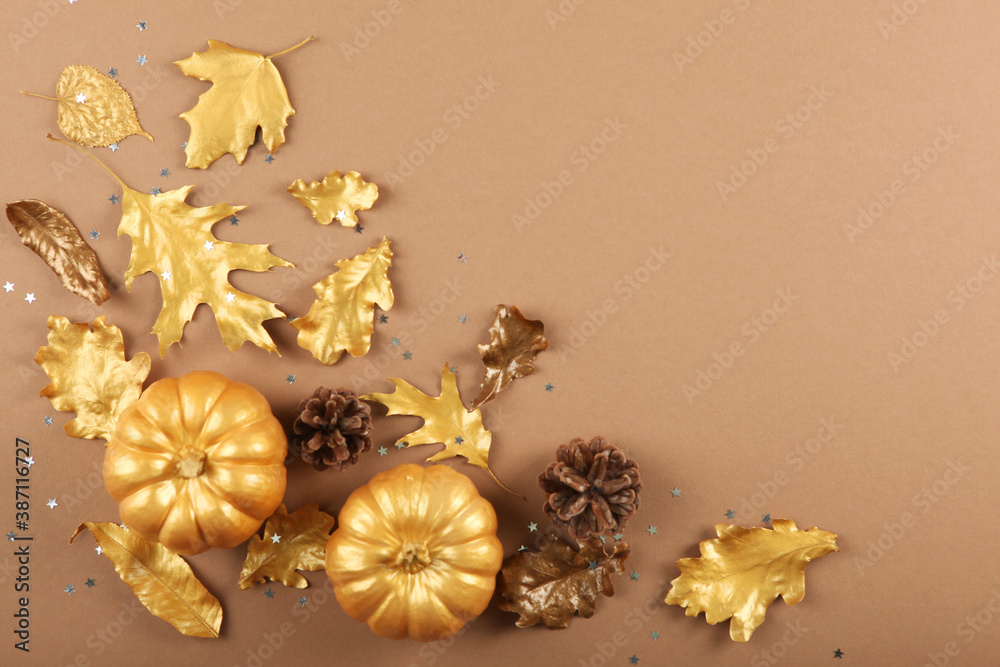 Fototapeta premium Beautiful stylish autumn background with golden leaves and pumpkins top view with place for text