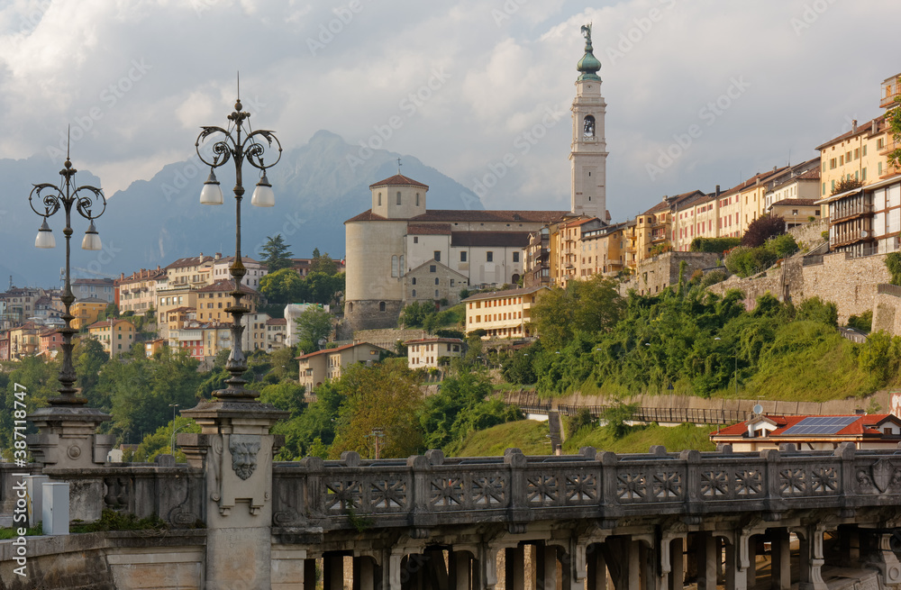 Photography Skyline of Belluno, Italy, with the Vittoria bridge over the river Piave in the