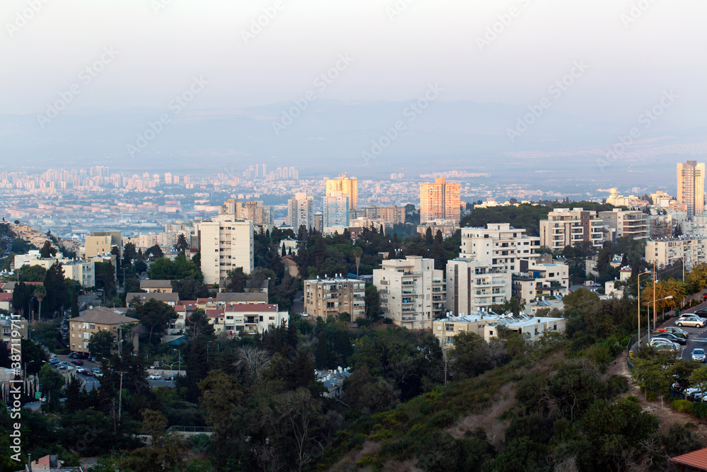 Modern urban architecture in Haifa, Israel. Fall season. Cityscape and skyline at sunset