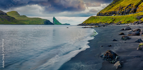 Gloomy summer scene of Faroe Islands and Tindholmur cliffs on background. Panoramic morning view of Vagar island, Denmark, Europe. Traveling concept background. photo