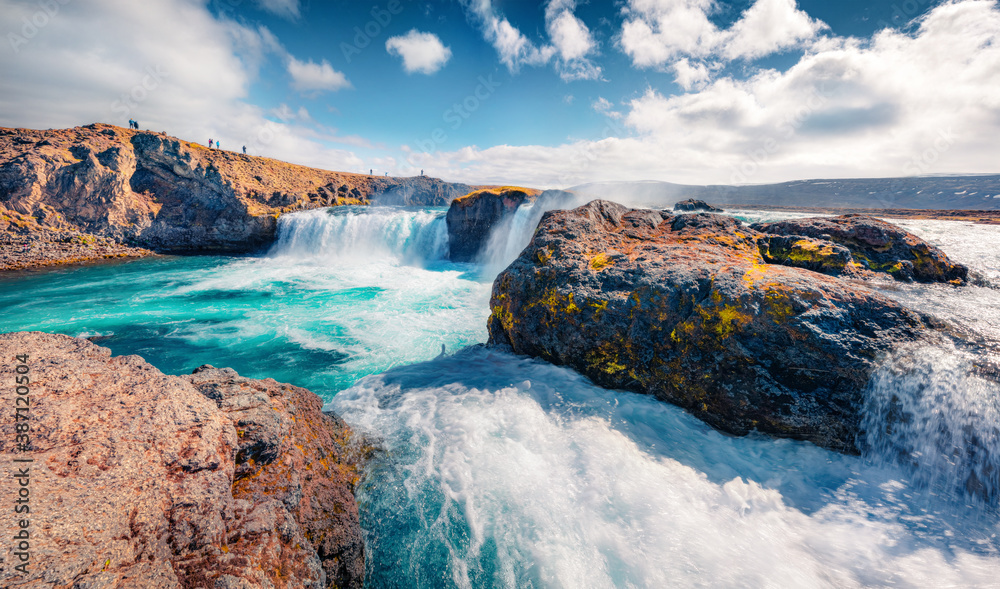 Magnificent summer view of Skjalfandafljot river, Iceland, Europe. Bright morning scene of Godafoss, spectacular waterfall plunging over a curved, 12m-high precipice.