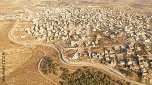 Israel and Palestine divided by Security wall Aerial view
Aerial view of Left side Anata Palestinian town and Israeli neighbourhood Pisgat zeev  
 photo