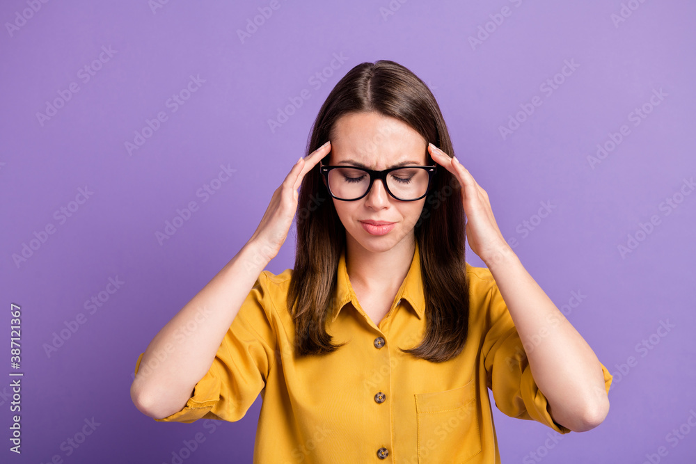 Photo of young stressed lady hands hold head eyes closed wear glasses yellow shirt isolated violet color background