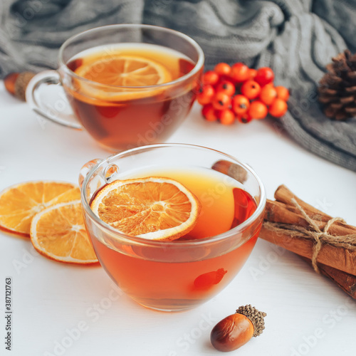 Wallpaper Mural Cup of tea with lemon, cinnamon, pine cones on white table. Cozy autumn lifestyle composition Torontodigital.ca