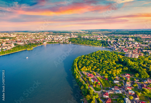 View from flying drone of Ternopil lake. Splendid summer sunset on Seret river. Beautiful morning cityscape of Ternopil town, Ukraine, Europe. Traveling concept background. photo
