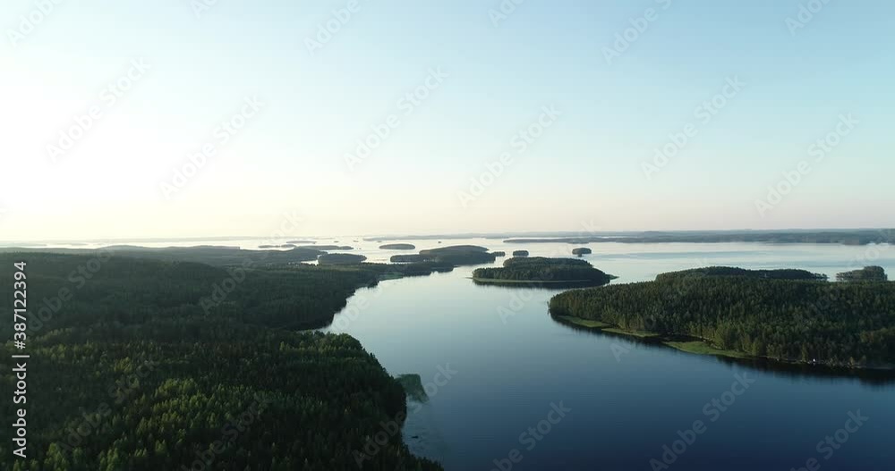 A calm evening landscape with lake and islands. Dramatic and picturesque scene. Popular tourist attraction. Exploration travel world. Paijanne National park. Finland. A calm evening landscape with lake and islands. Dramatic and picturesque scene. Popular tourist attraction. Exploration travel world. Paijanne National park. Finland.