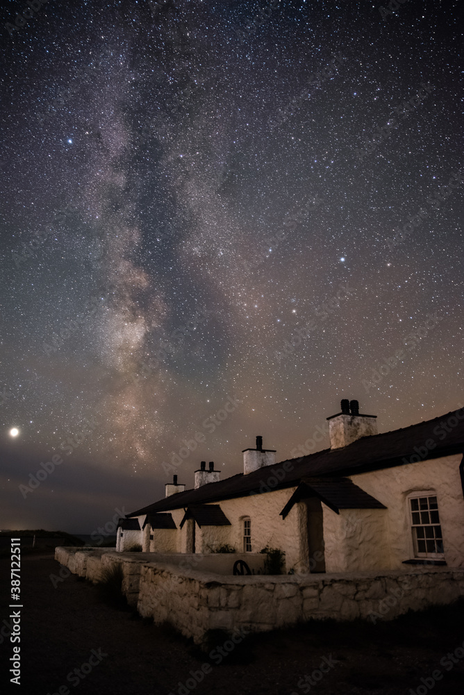 The Milky Way over Llanddwyn pilots cottages at Ynys Llanddwyn on Anglesey, North Wales.