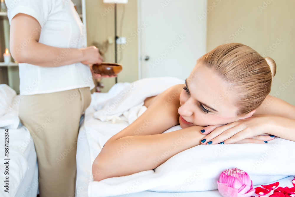 Beautiful young attractive Caucasian woman having body massage by Thai Masseur in spa salon. Beauty treatment and body care lifestyle concept Beautiful young attractive Caucasian woman having body massage by Thai Masseur in spa salon. Beauty treatment and body care lifestyle concept