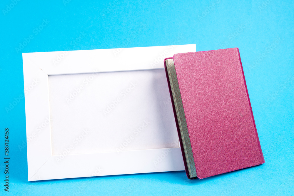 Fototapeta premium empty picture frame with passport because of freedom of travel