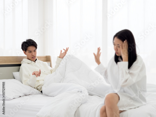 Selective focus, Lesbian couple having argument in the bedroom.