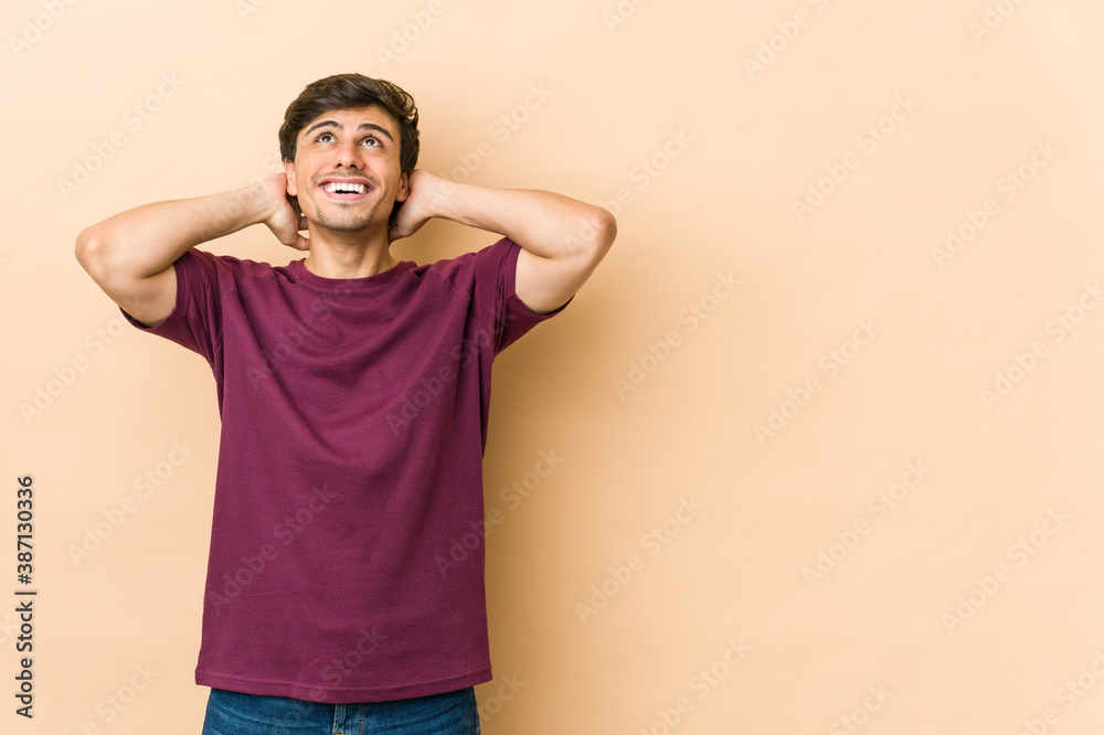 Young cool man feeling confident, with hands behind the head. Young cool man feeling confident, with hands behind the head.