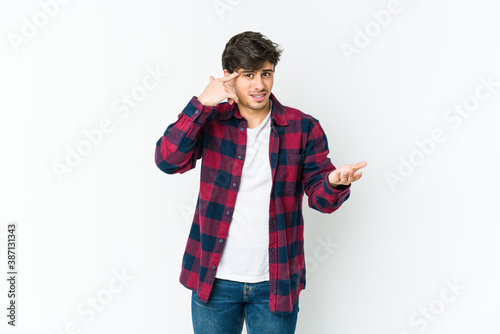 Young cool man showing a disappointment gesture with forefinger.
