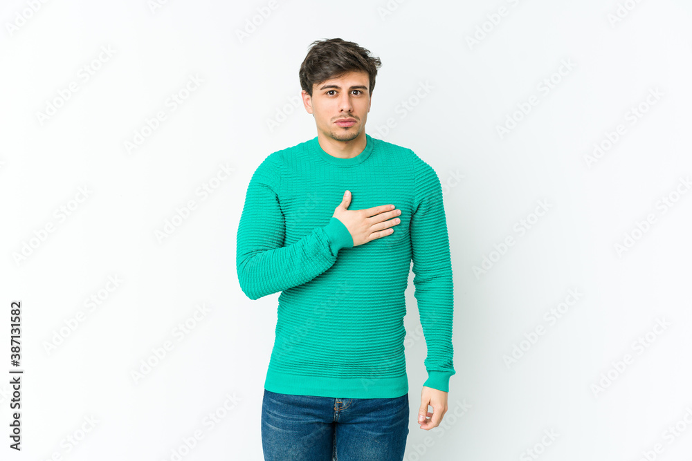 Fototapeta premium Young cool man taking an oath, putting hand on chest.