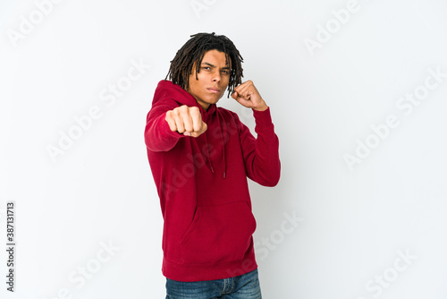 Young african american rasta man throwing a punch, anger, fighting due to an argument, boxing.