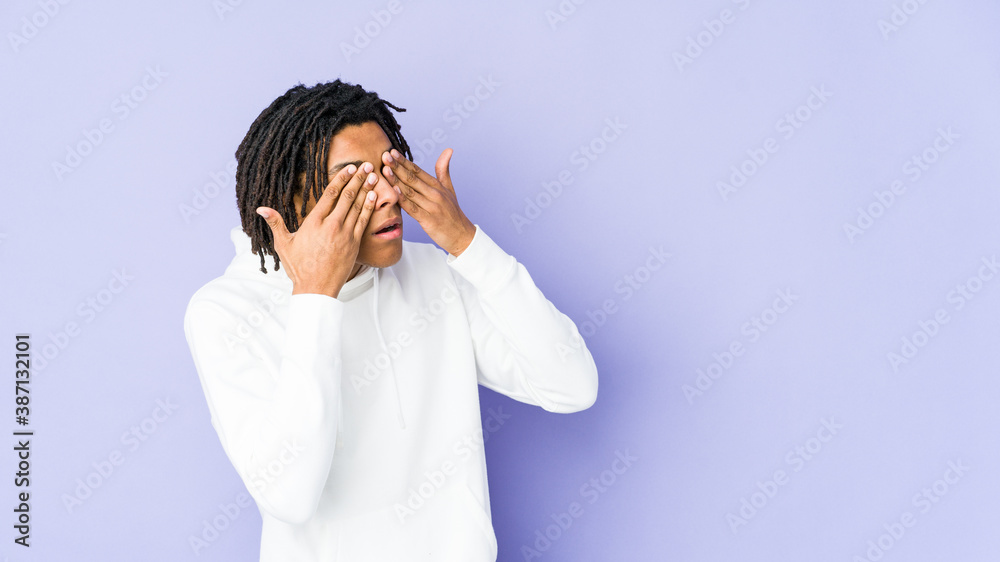 Young african american rasta man afraid covering eyes with hands. Young african american rasta man afraid covering eyes with hands.