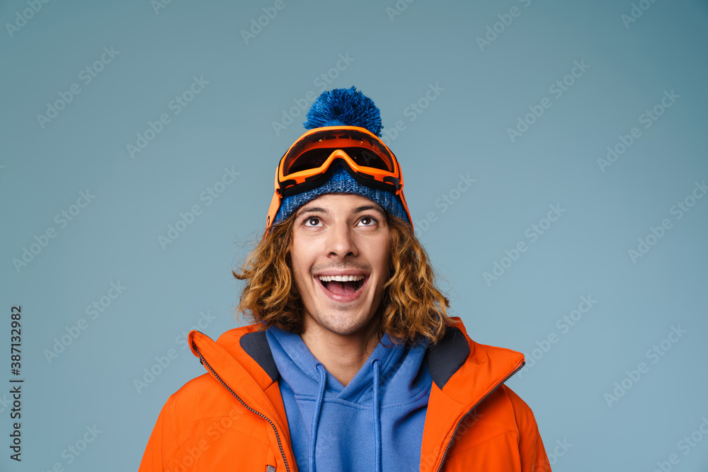 Caucasian joyful sportsman smiling and looking upward Caucasian joyful sportsman smiling and looking upward