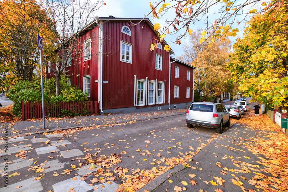 The old wooden district Toukola of Helsinki, Finland. Red old wooden building. Autumn cityscape.