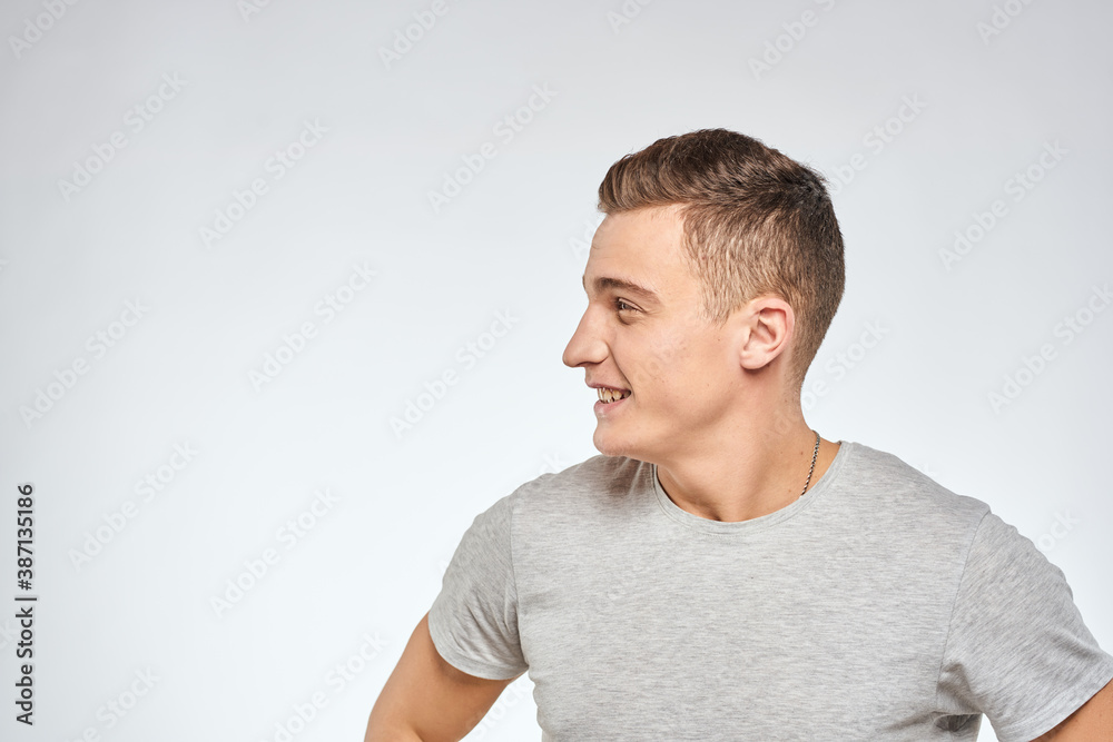 man in gray t-shirt emotions light background cropped view man in gray t-shirt emotions light background cropped view