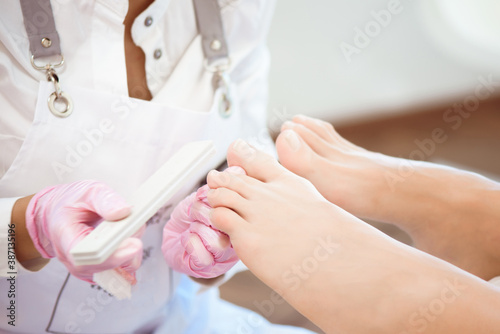 Woman feet receiving pedicure in a Day Spa