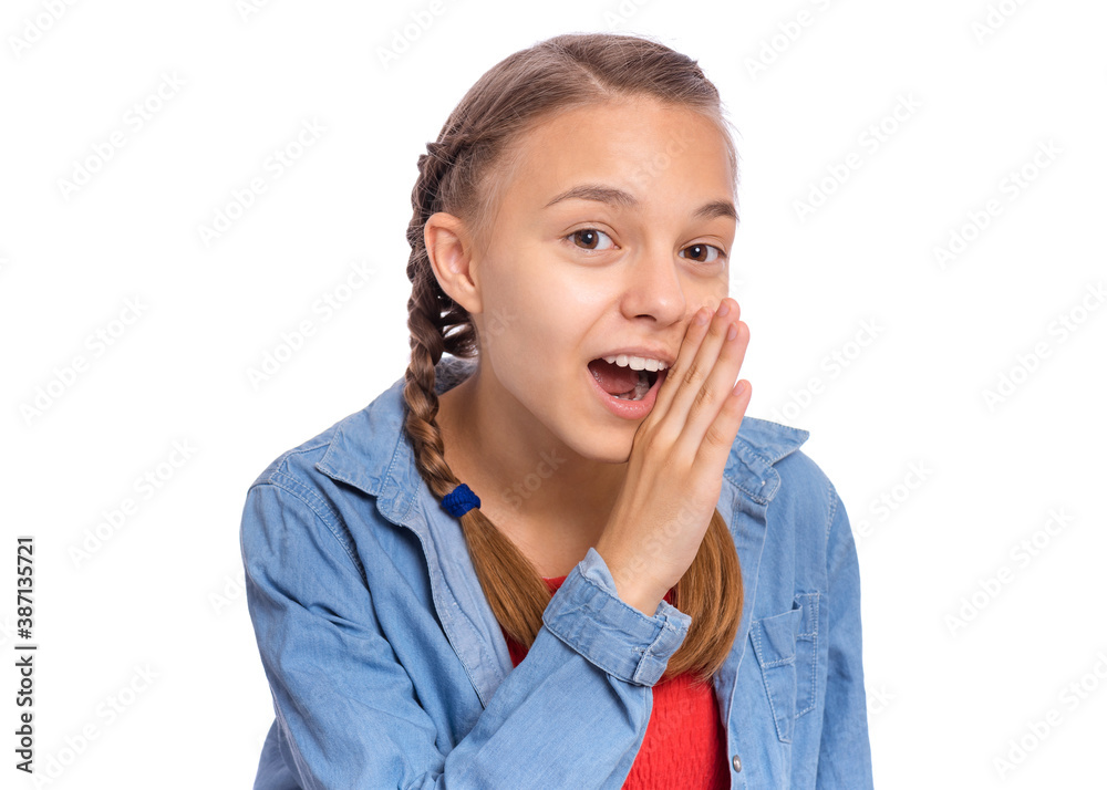 Happy teenage girl whispers, says something, covering her mouth with a palm, isolated on white background Happy teenage girl whispers, says something, covering her mouth with a palm, isolated on white background