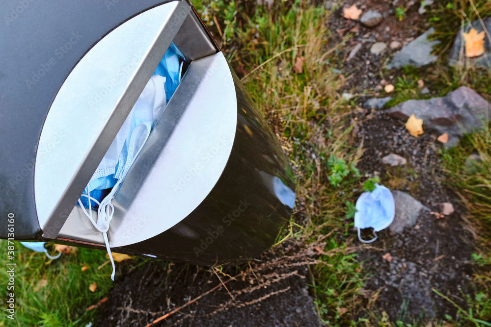 The used face masks in the street garbage bin during the COVID-19 pandemic in Finland.