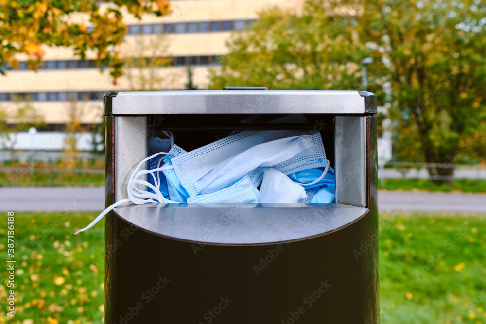 The used face masks in the street garbage bin during the COVID-19 pandemic in Finland.