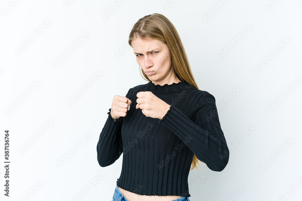 Young blonde woman isolated on white background showing fist to camera, aggressive facial expression. Young blonde woman isolated on white background showing fist to camera, aggressive facial expression.