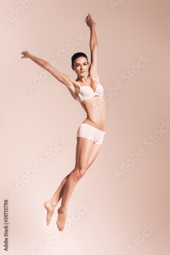 beautiful jumping woman in underwear in sepia