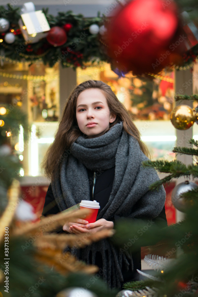 Happy teen girl with coffee at christmas market in evening. winter holidays, hot drinks and people concept. Merry Christmas and Happy Holidays. Christmas eve
