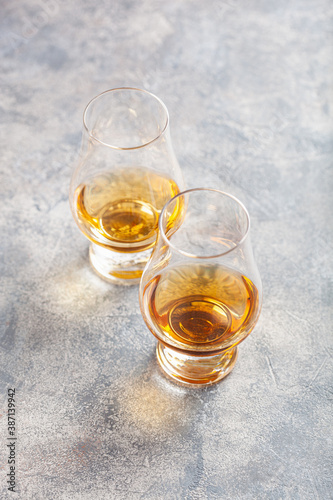 glass of whisky spirit brandy on gray concrete background