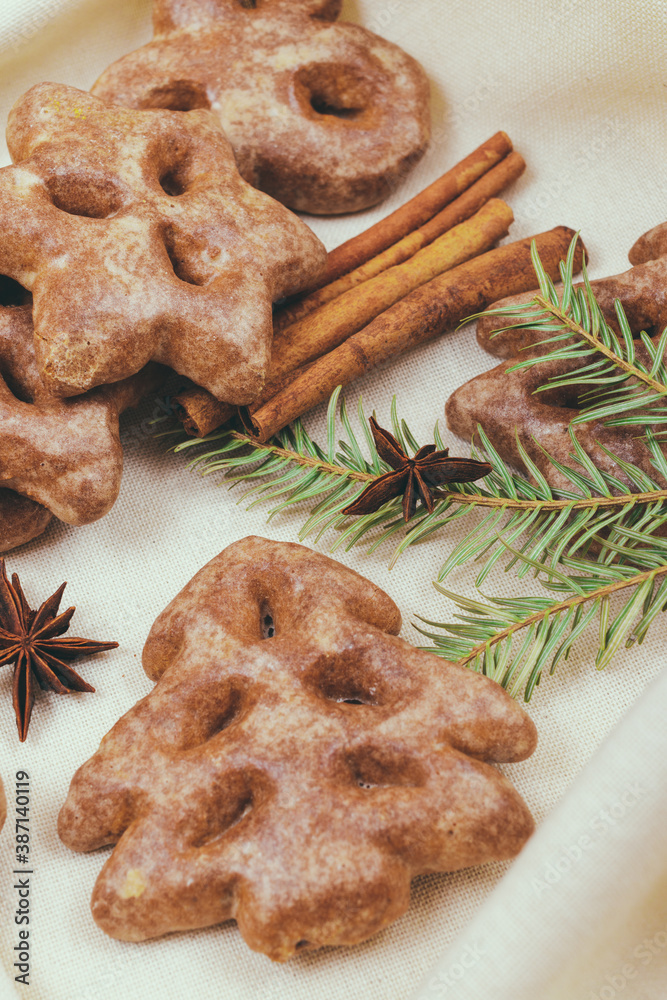 Ginger cookies, some spices and fir tree branch on the tablecloth. Ginger cookies, some spices and fir tree branch on the tablecloth.