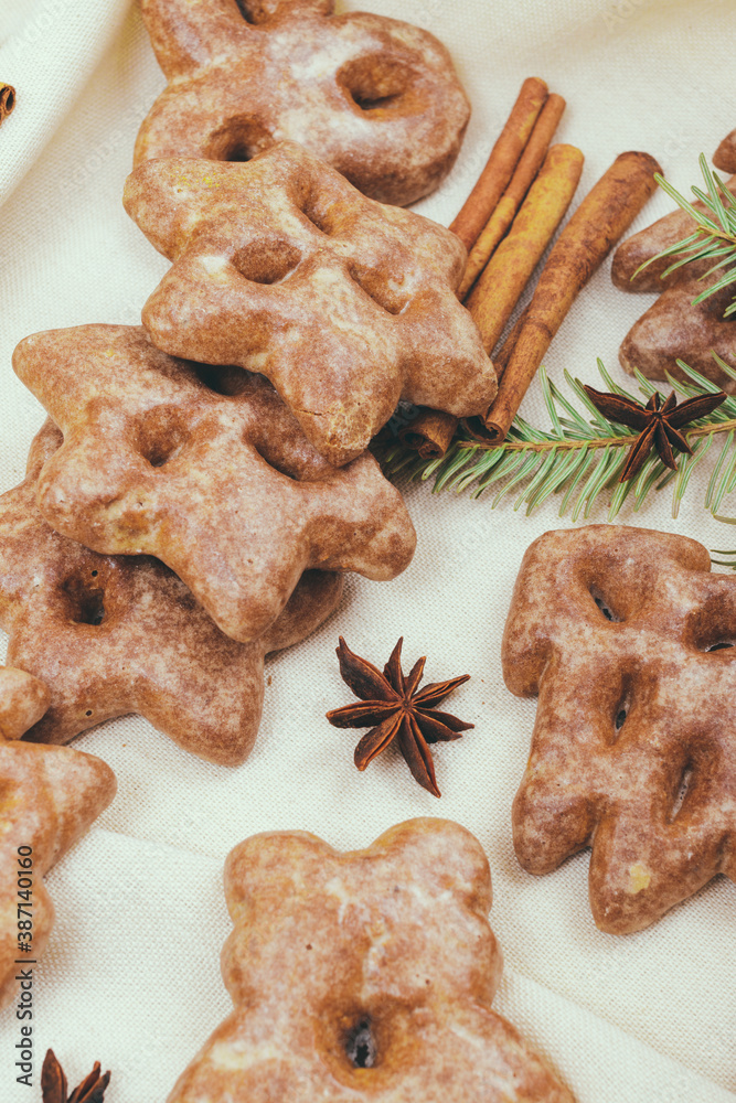 Ginger cookies, some spices and fir tree branch on the tablecloth. Ginger cookies, some spices and fir tree branch on the tablecloth.