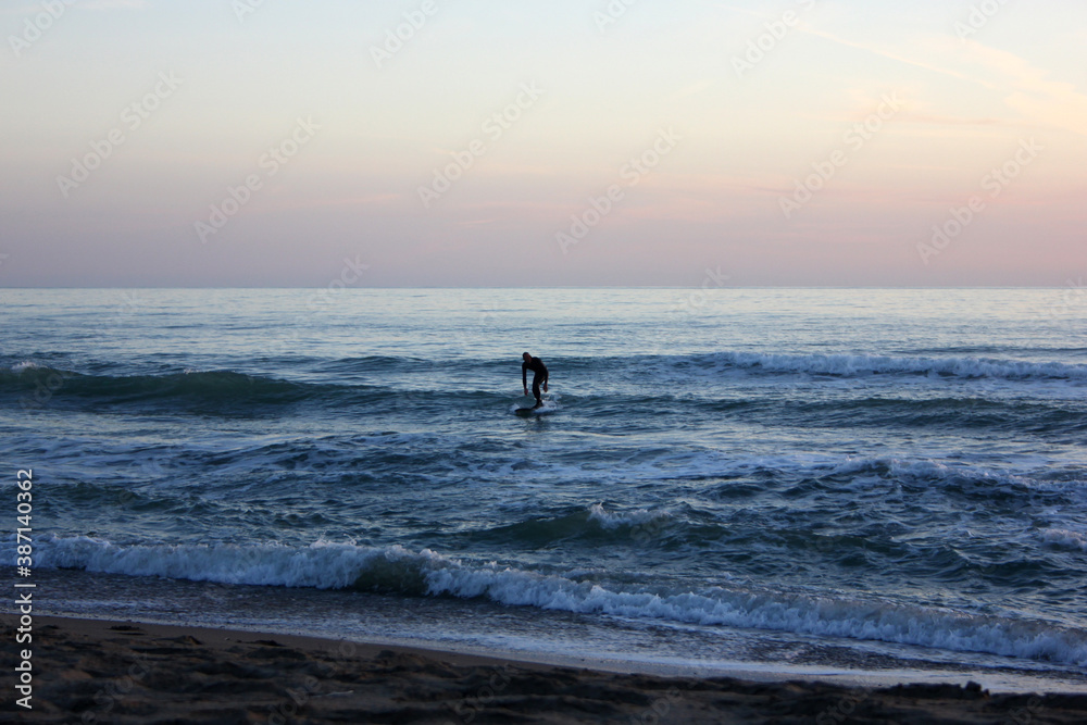 Fototapeta premium Surfing in corona times at Forte dei Marmi, Tuscany, Italy