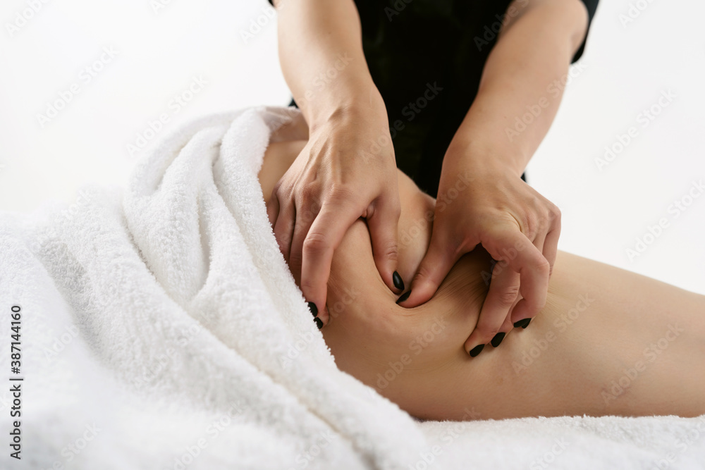 Fat burning massage. masseur making anti cellulite massage for young woman in wellness center or beauty salon. Perfect skin beauty concept Fat burning massage. masseur making anti cellulite massage for young woman in wellness center or beauty salon. Perfect skin beauty concept