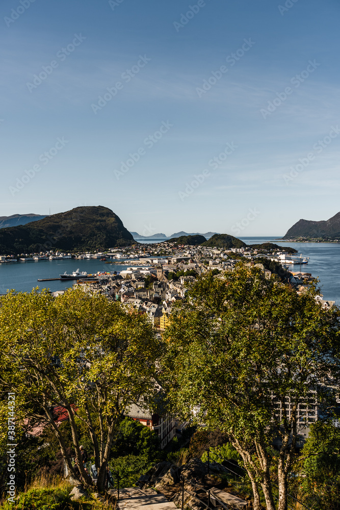 View of Ålesund in Norway on a sunny day with mountain ranges in the background