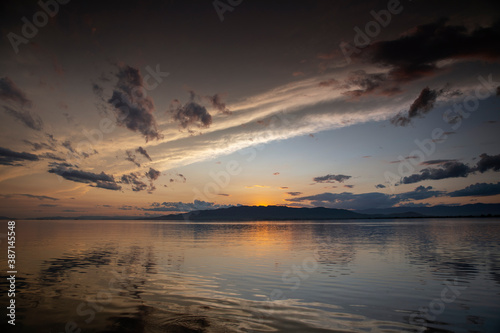 A sunset over water with clouds © Dan Talson