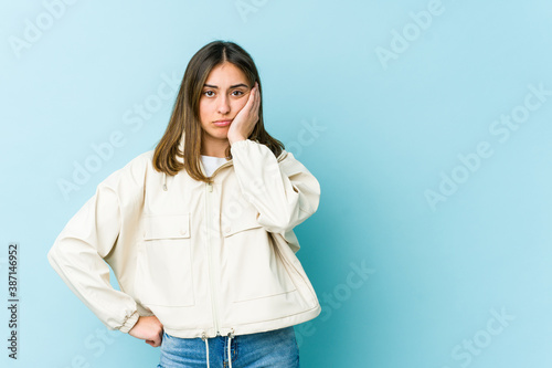 Young caucasian woman who feels sad and pensive, looking at copy space.
