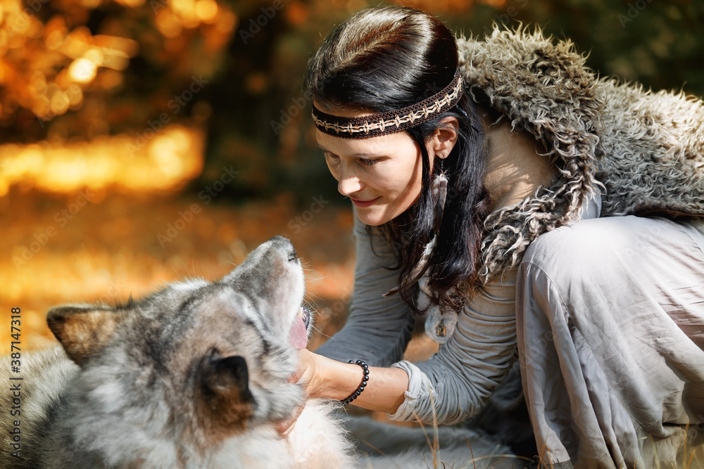 Woman with wolf in the autumn forest Woman with wolf in the autumn forest