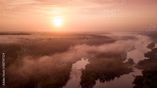 amazing aerial view of foggy morning river and colorful trees. drone shot © ver0nicka